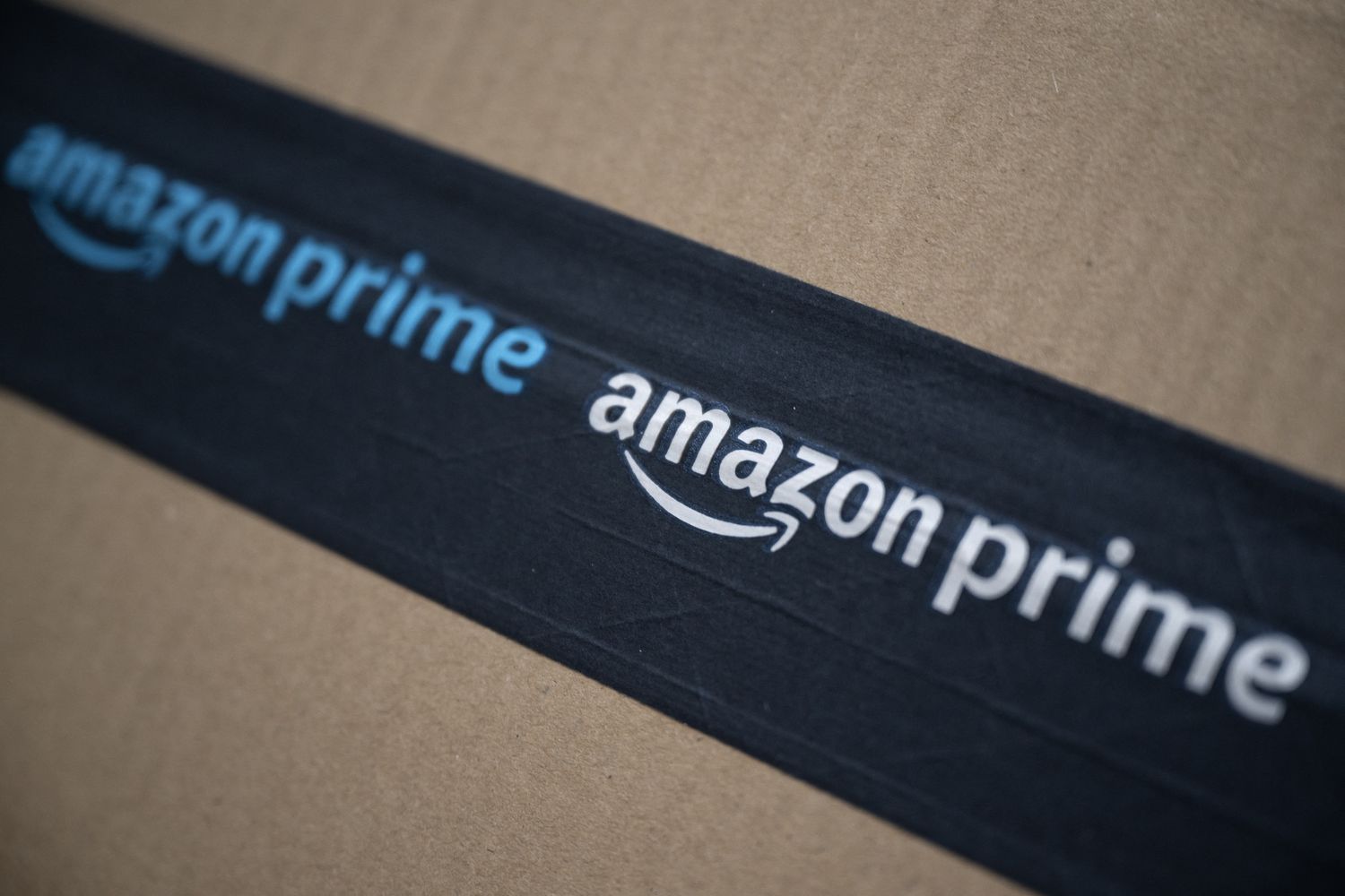 Amazon's logo on a brown cardboard parcel. 