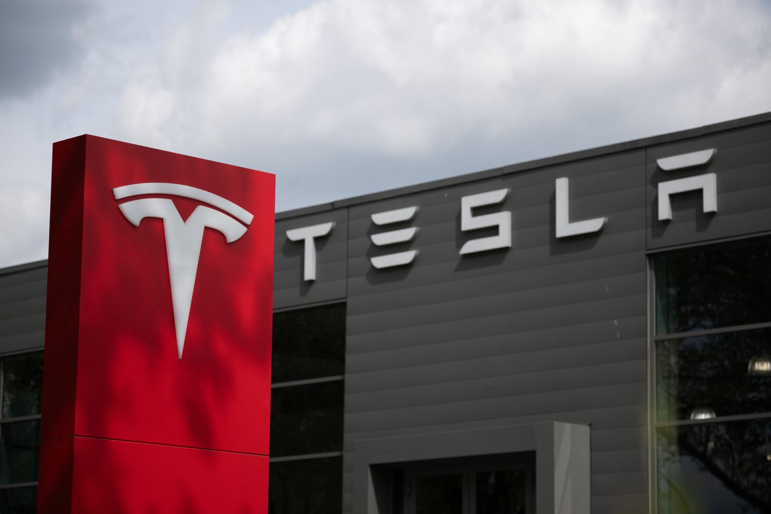The Tesla logo on a car dealership in Berlin, Germany.