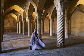 Woman walking in a mosque in Iran