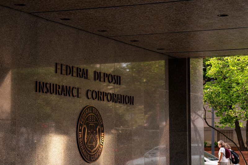 People walk past the he Federal Deposit Insurance Corp. (FDIC) headquarters in Washington, DC.