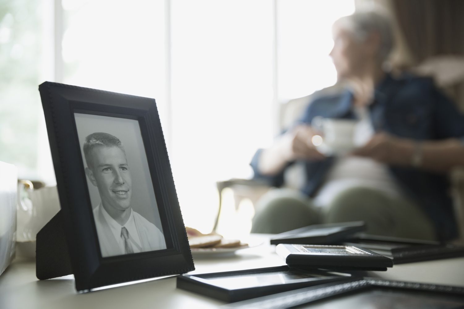 Old photograph of man with senior woman in background
