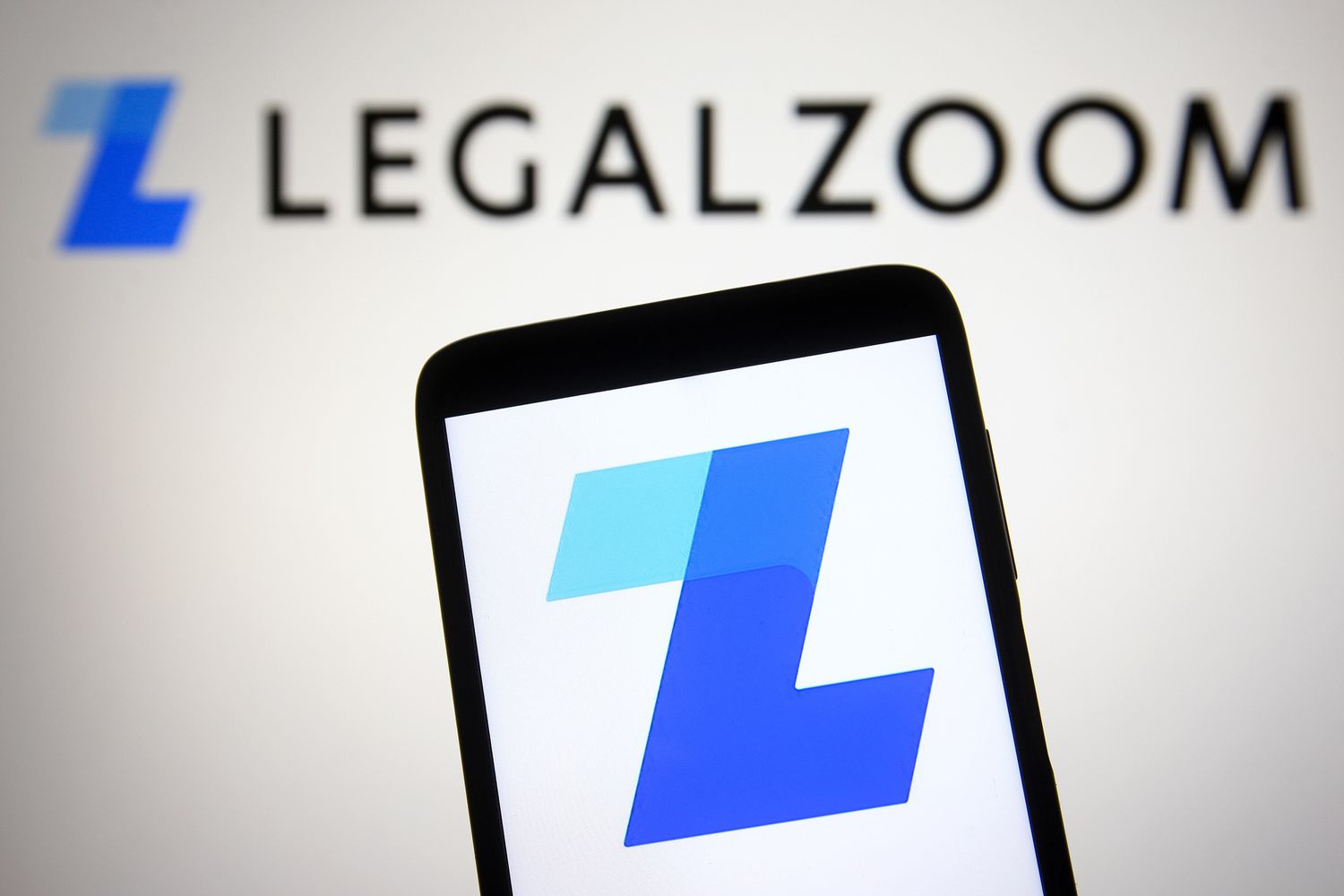A LegalZoom logo is seen on a smartphone and a PC screen