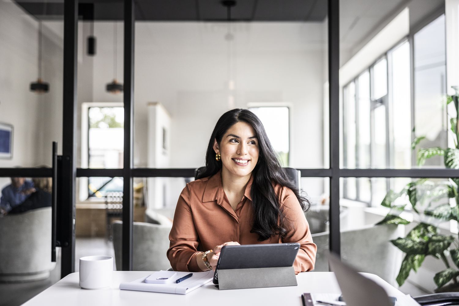Woman smiling at her desk.