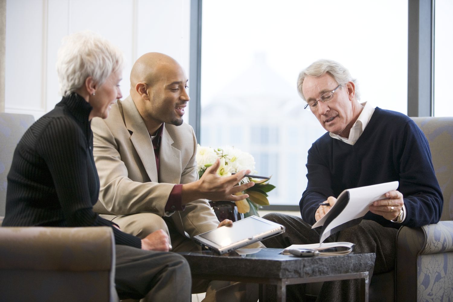 Older couple discussing paperwork with a young man
