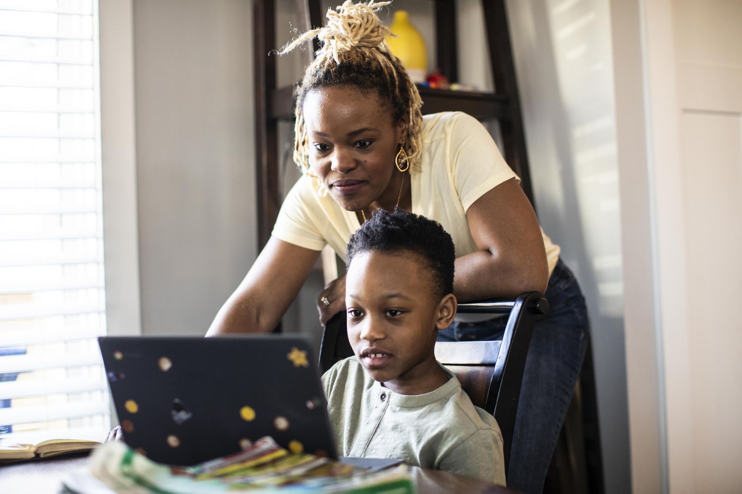Mother reading about 529 strategies that can maximize student aid options for her son