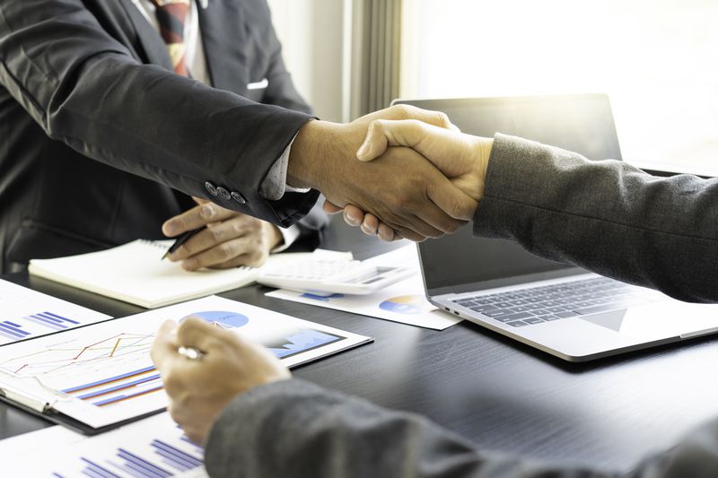 A hand shake over a desk