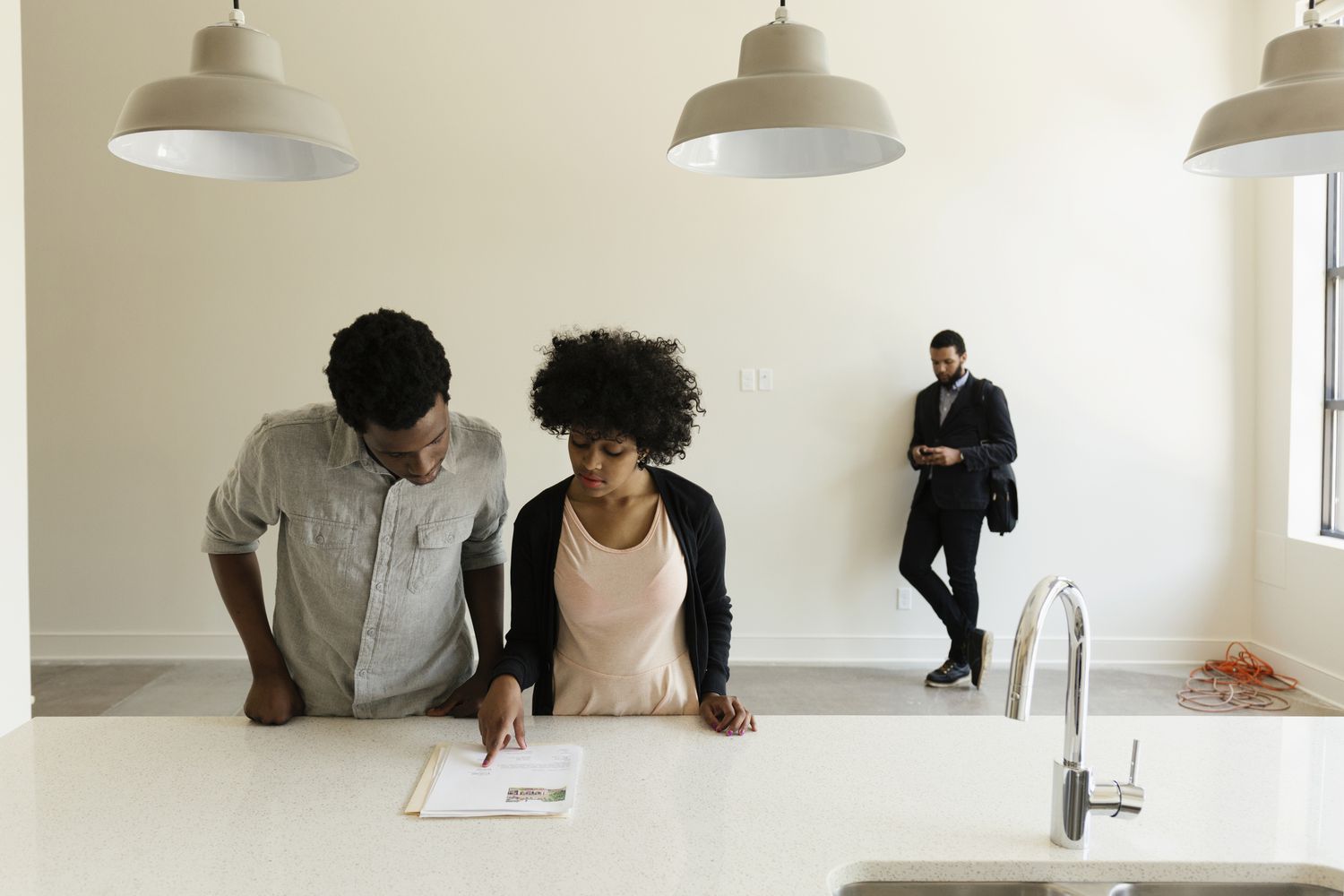 Couple reading paperwork in new house.