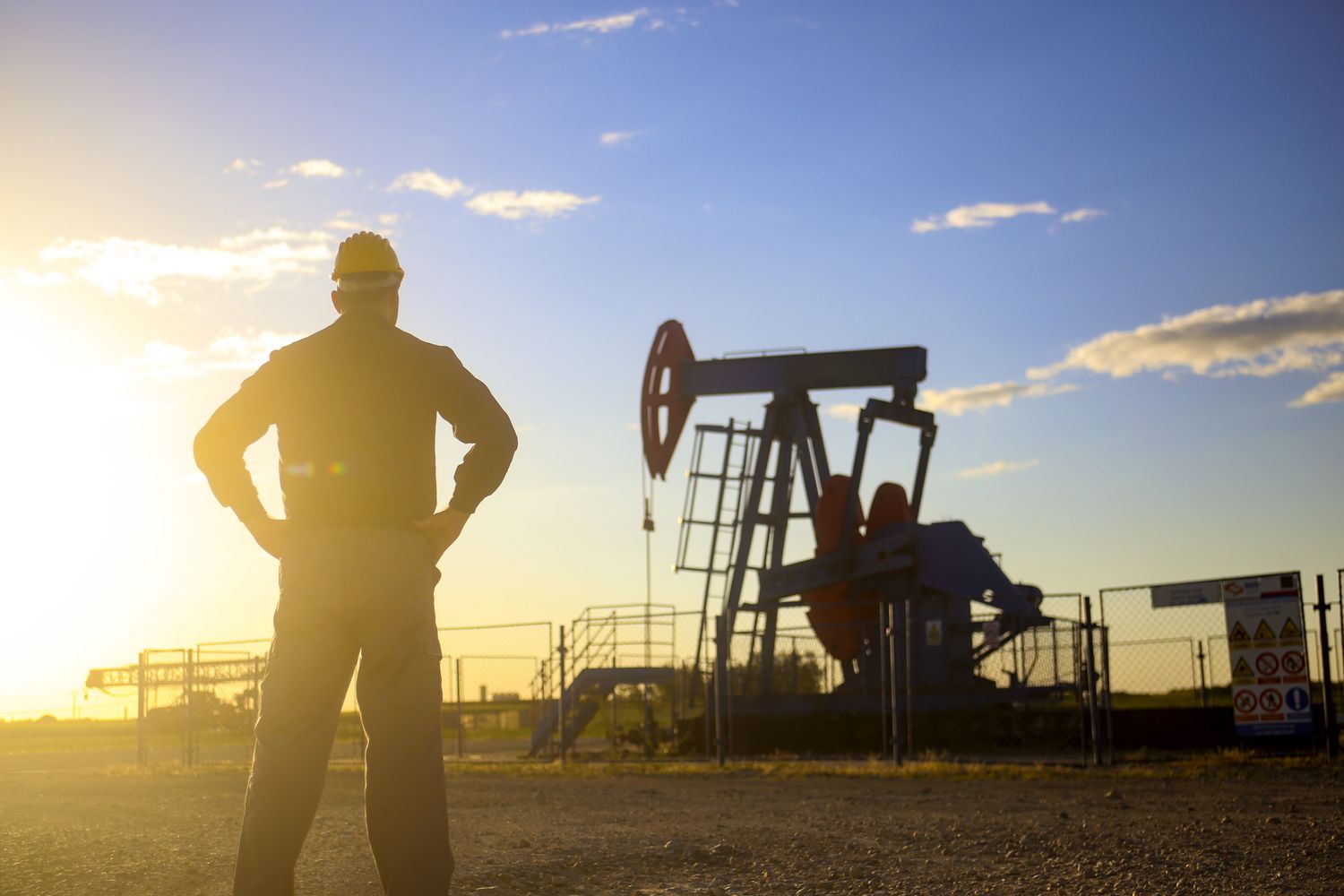 Worker standing in an oil field