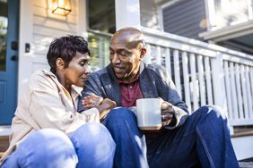 A couple sitting on front porch