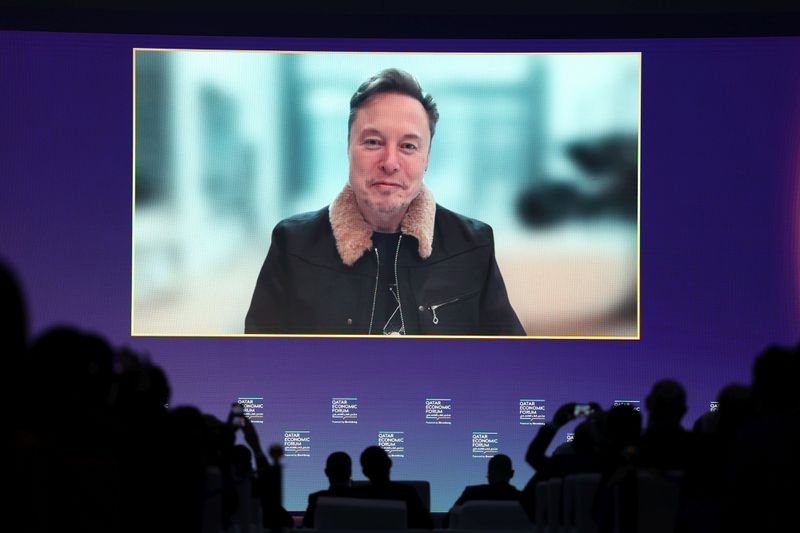 Tesla CEO Elon Musk appears on a screen at the Qatar Economic Forum on May 20, 2025