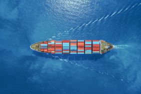 Aerial view of a ship carrying containers in the water