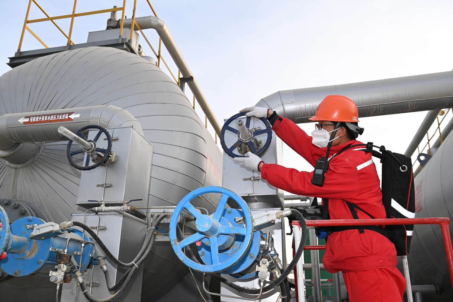 Engineer inspecting pipes in an oil and gas facility