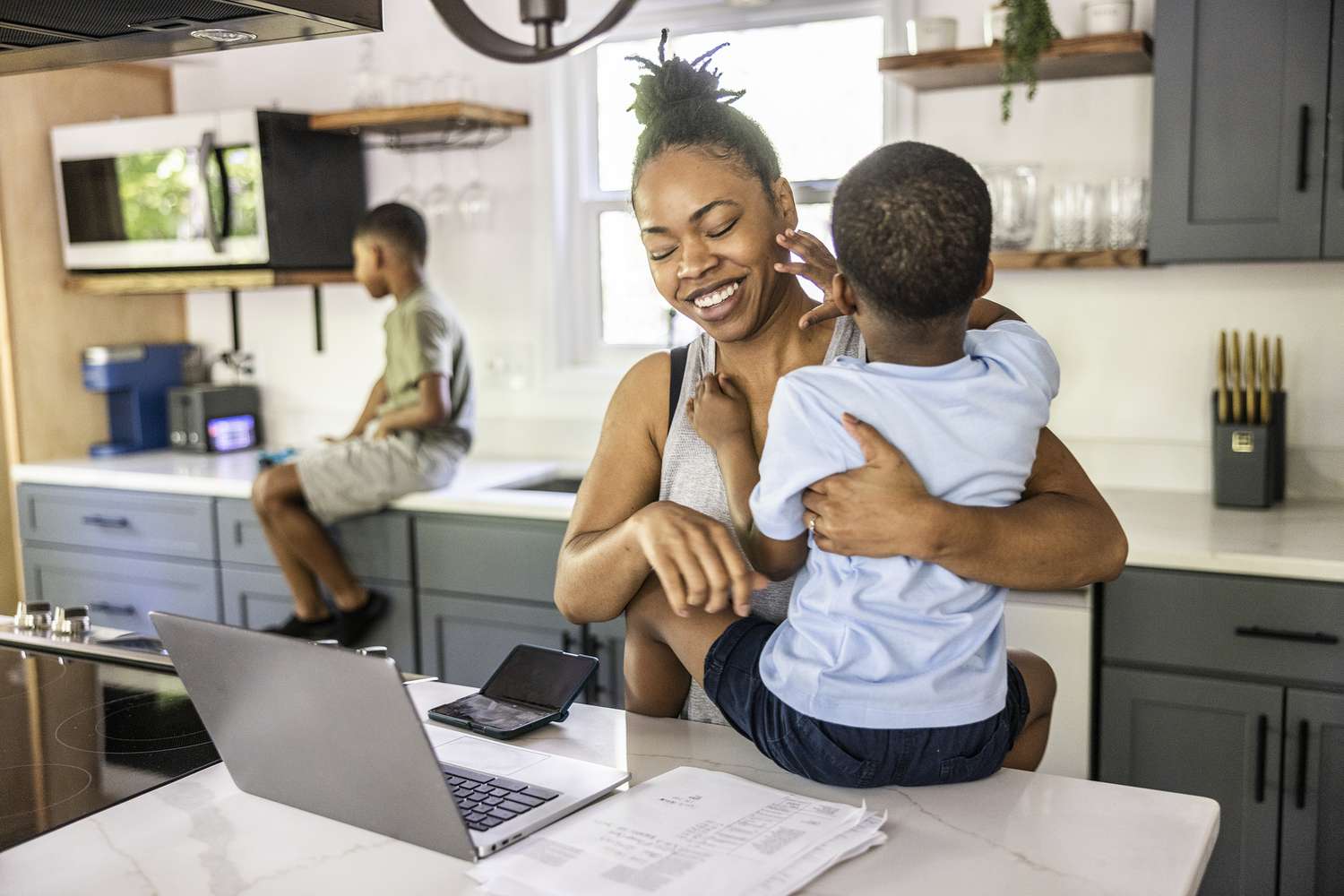Mother with two children in kitchen