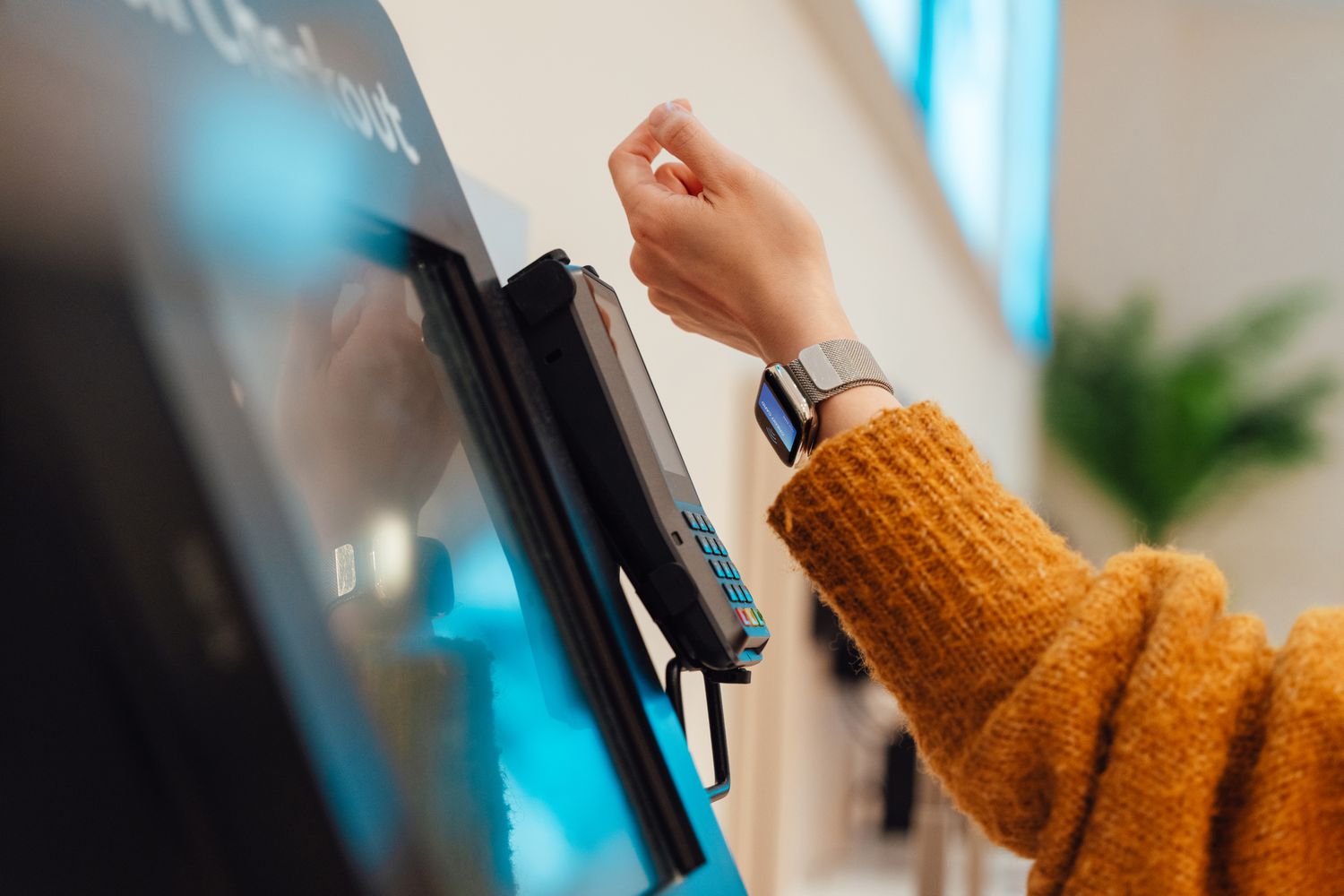 A customer paying for a transaction with a smart watch.