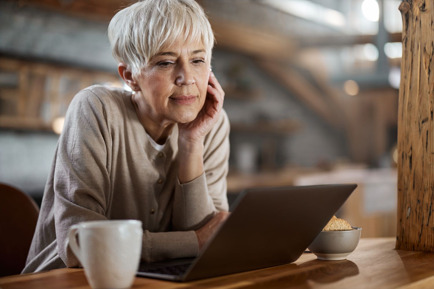 Mature woman working on a computer at home.
