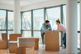 A couple with moving boxes in an apartment