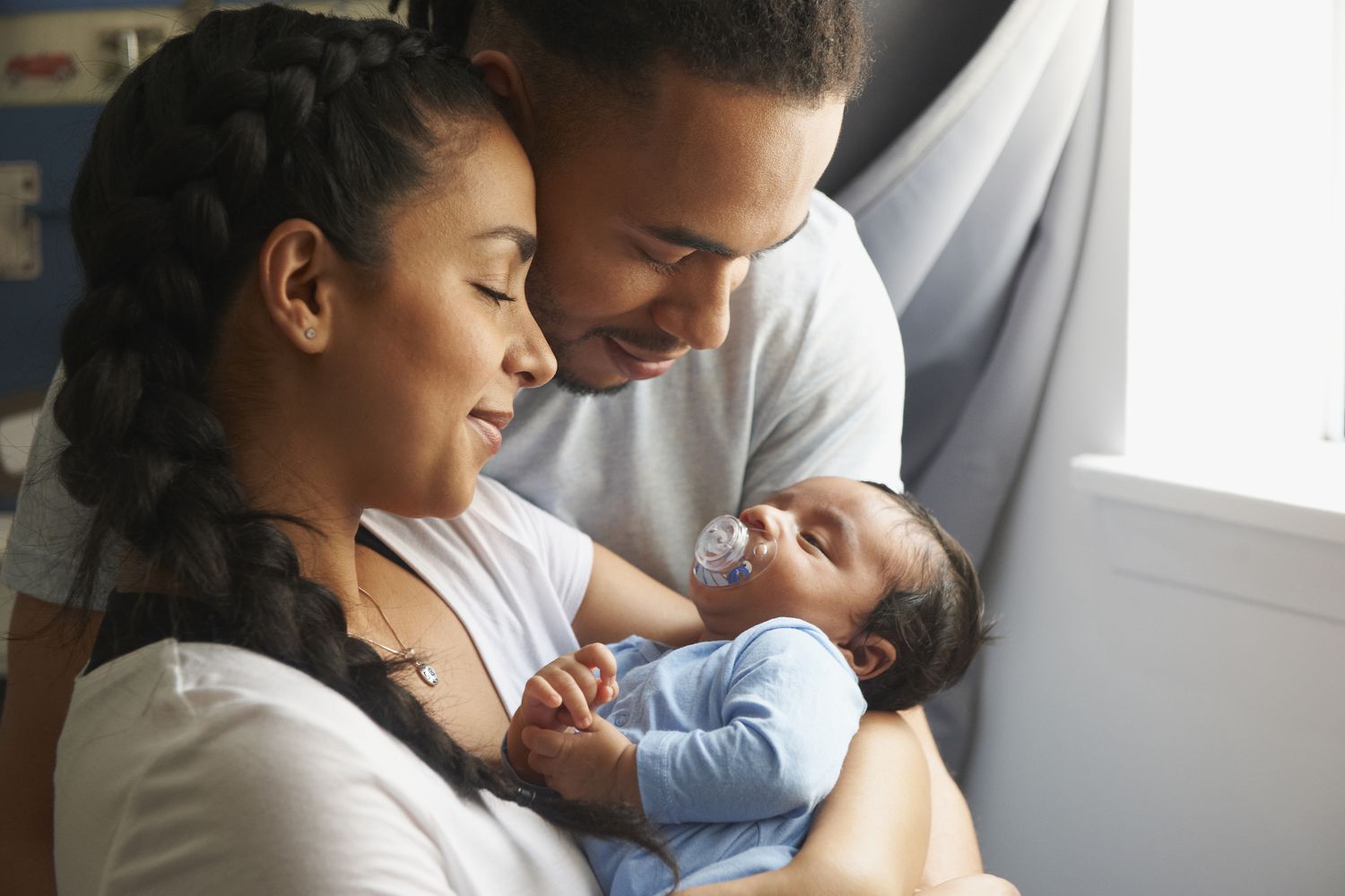Couple holding a newborn baby. 
