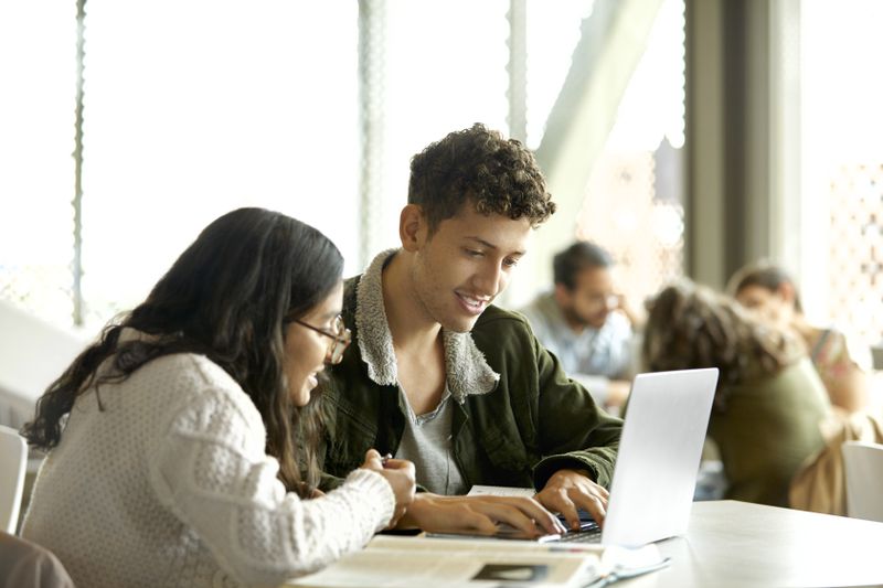 Two students comparing subsidized and unsubsidized student loans
