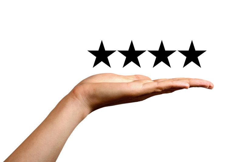 Open palm of a hand presenting four stars