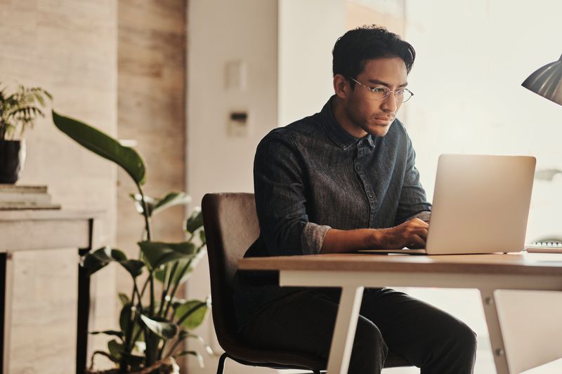 A man works on a laptop
