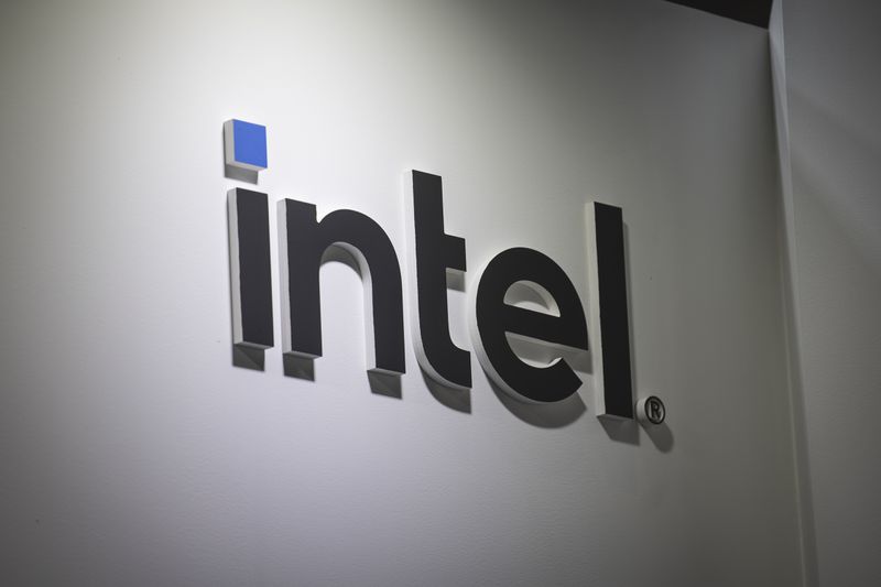 The black and blue Intel logo is seen on a white wall.