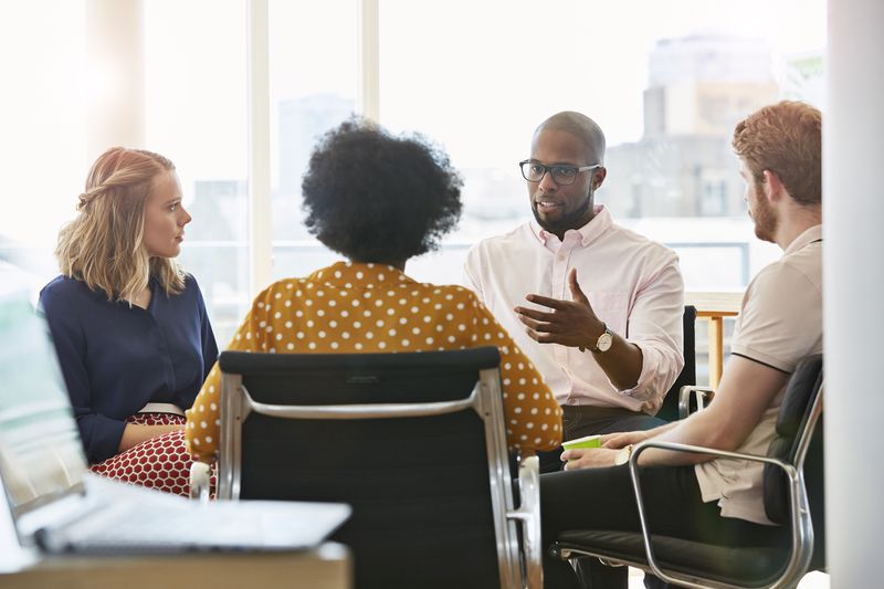 Employees having a meeting in a modern office.