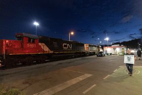 A Teamsters union member walks the picket line at the entrance of CN Rail Lynn Creek Yard on August 21, 2024 in North Vancouver, British Columbia,