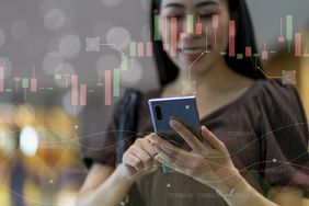 A person looking at a cell phone with an overlay of a price action chart.
