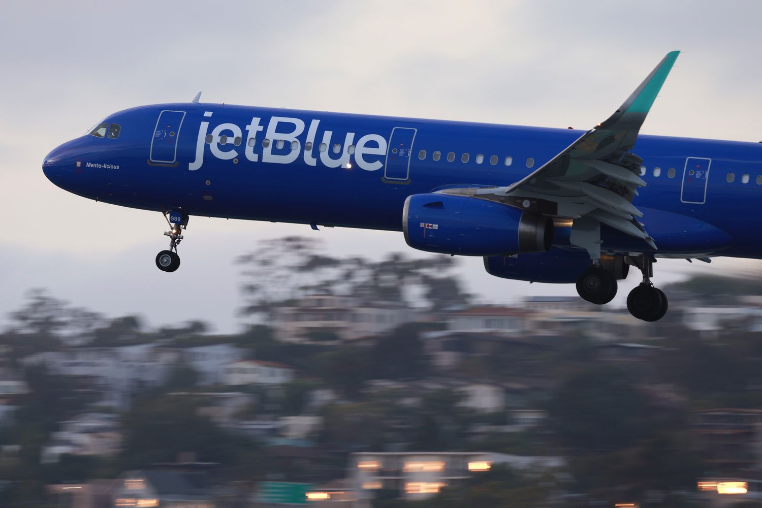 A JetBlue Airways Airbus A321 airplane approaches San Diego International Airport