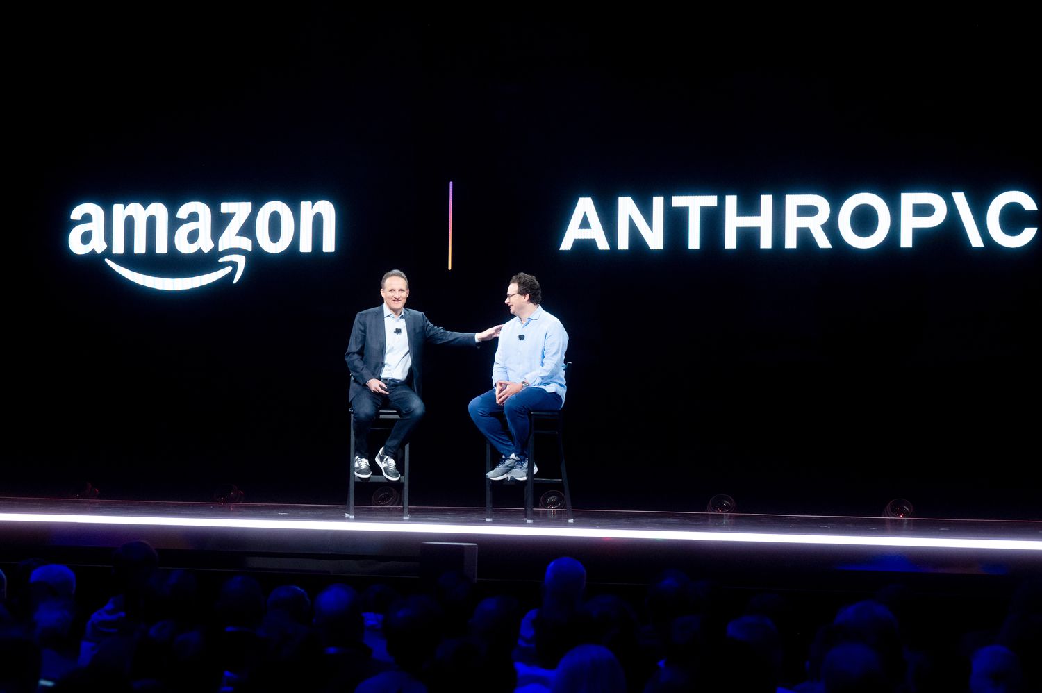 Amazon Web Services (AWS) CEO Adam Selipsky speaks with Anthropic CEO and co-founder Dario Amodei at a conference.