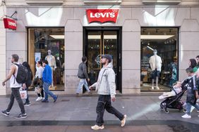 Pedestrians walk past a Levi's store in Madrid, Spain