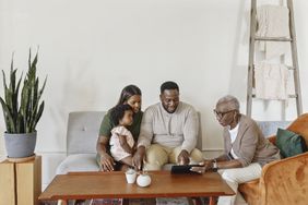 Financial advisor explaining paperwork to young couple with child