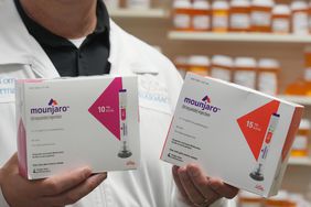 A pharmacist holds boxs of Eli Lilly & Co. Mounjaro brand tirzepatide medication arranged at a pharmacy in Provo, Utah