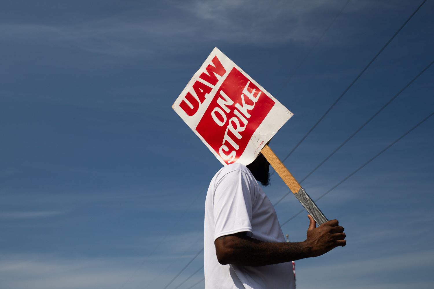 A "UAW On Strike" sign held on a picket line outside the General Motors Co. 