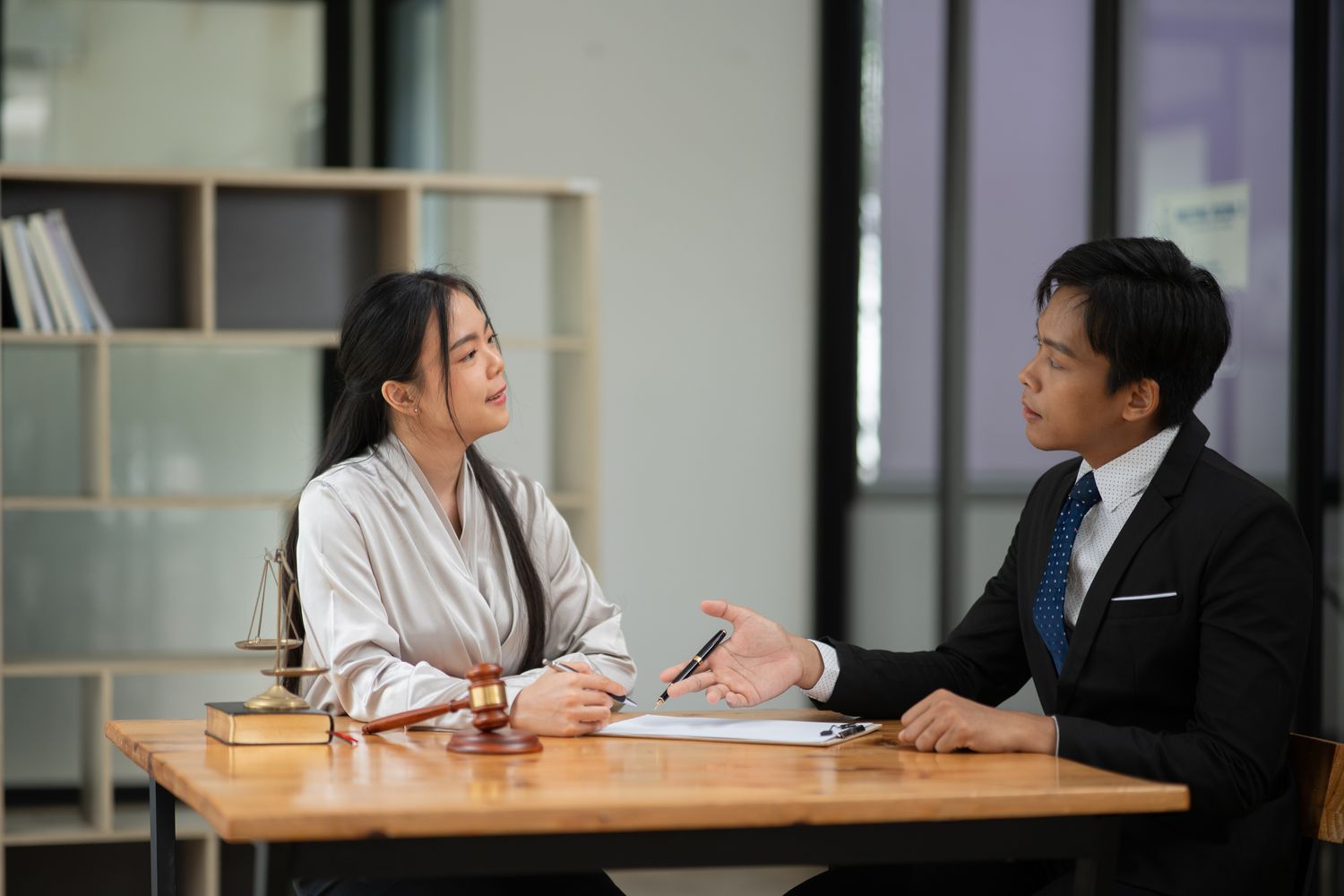 Lawyer discuss about potential judicial foreclosure with mortgage lender representative.