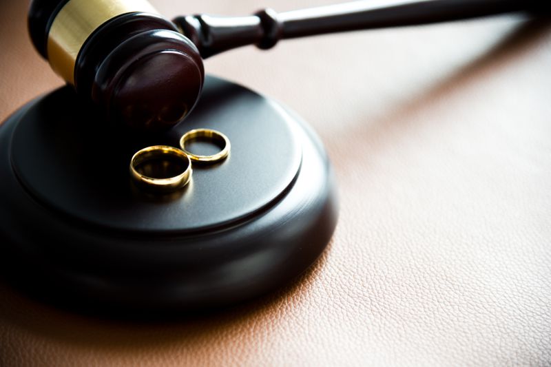 Illustration of divorce concept with two rings on gravel