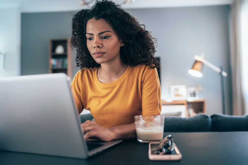 Woman reading tips for managing her student loan debt