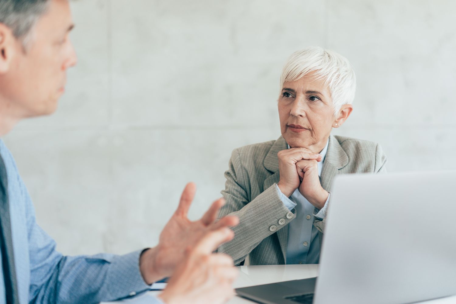A human resource officer answers questions about a retirement plan for a new employee.