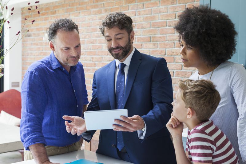 Insurance agent explains to a family of customers about the top insurance companies and their policies.