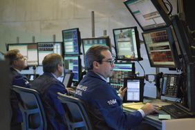 Traders working in front of banks of computers