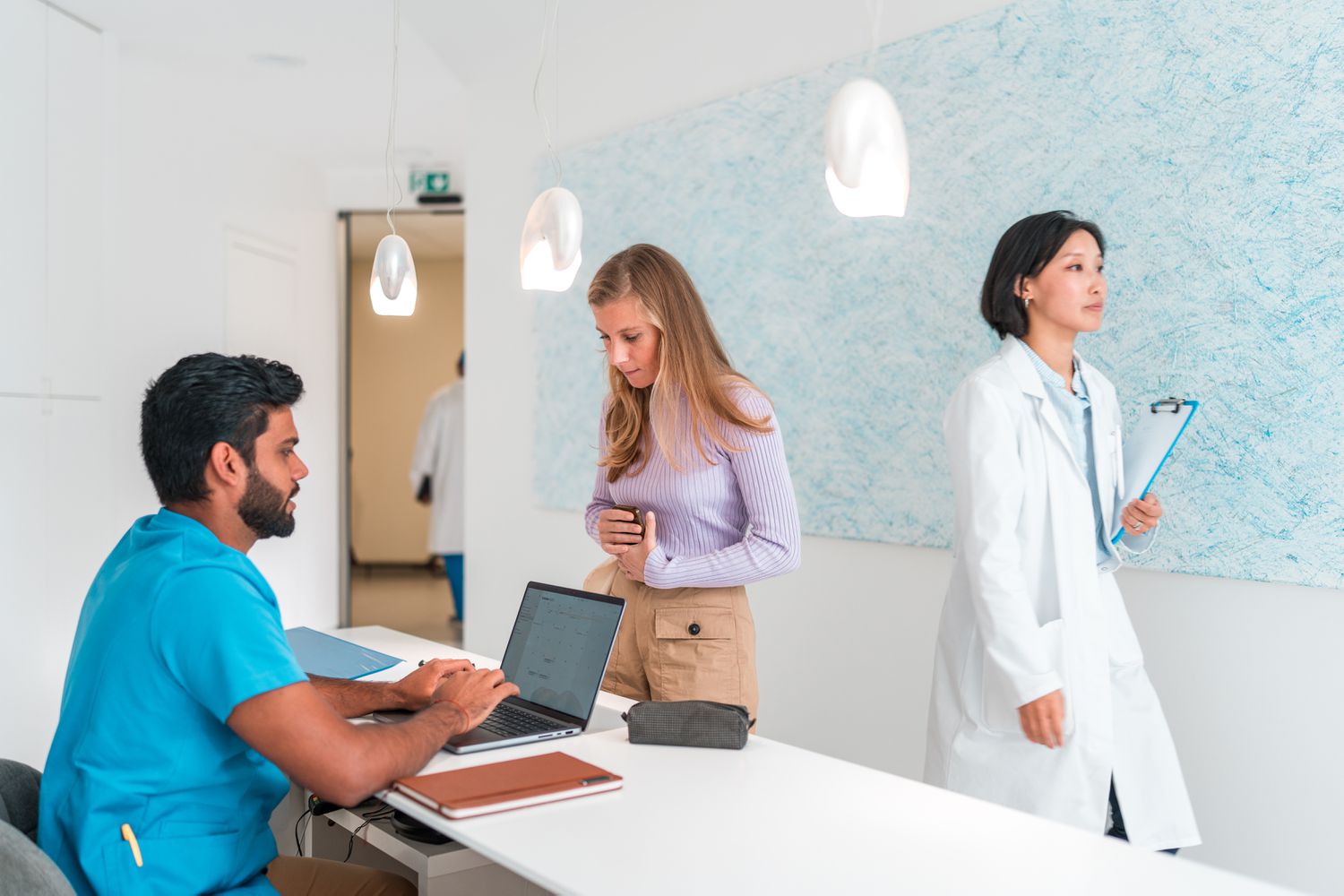 Female patient checking information about reception desk with a male nurse