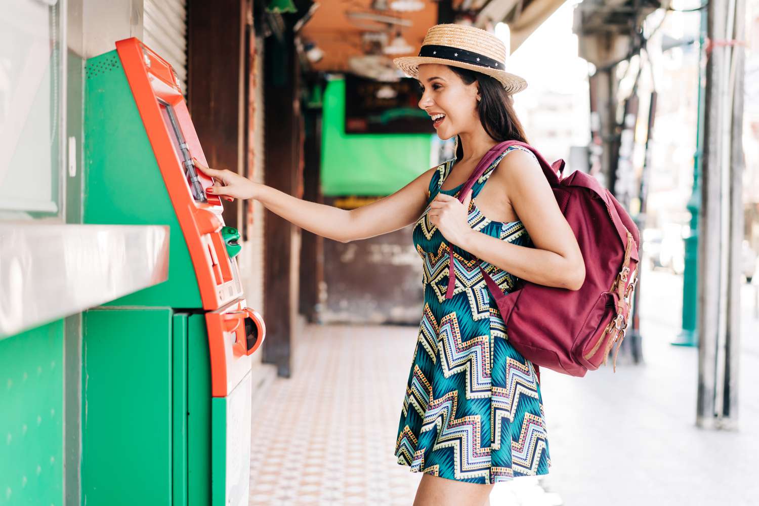 Young traveller checking out foreign transaction fee for cash withdrawal in ATM.
