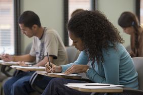 A young adult taking a test.