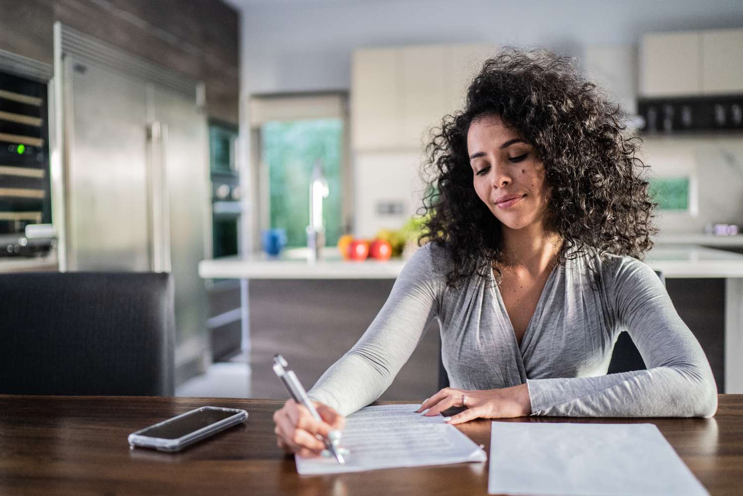 Woman doing paperwork related to her stated income/stated asset (SISA) mortgage