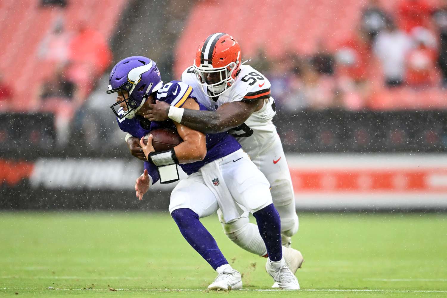 Winston Reid #59 of the Cleveland Browns sacks Jaren Hall #16 of the Minnesota Vikings during the second half of a preseason game at Cleveland Browns Stadium on August 17, 2024 in Cleveland, Ohio