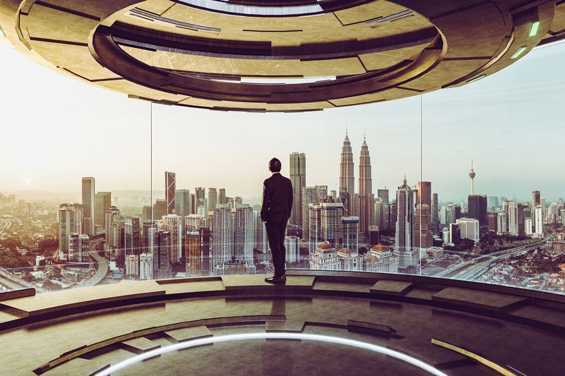 Businessman Looking at Cityscape While Standing in Modern Office