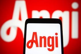 Angi Inc. logo is seen on a smartphone and a computer screen