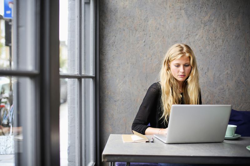 A woman uses a laptop. 