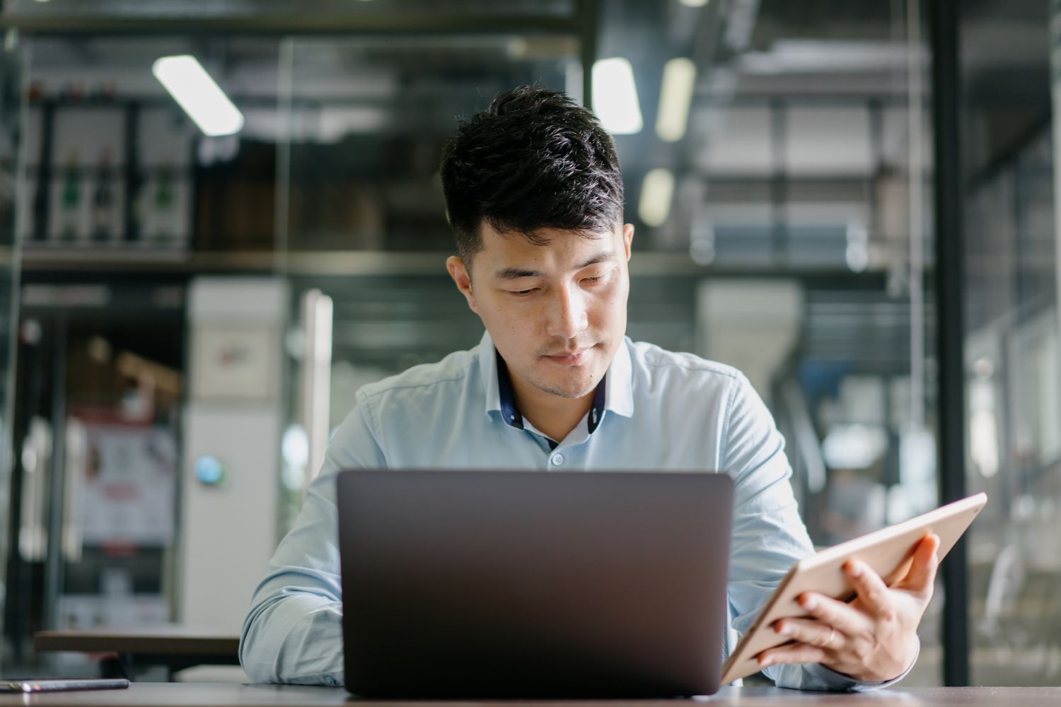 Young man working on a laptop and tablet