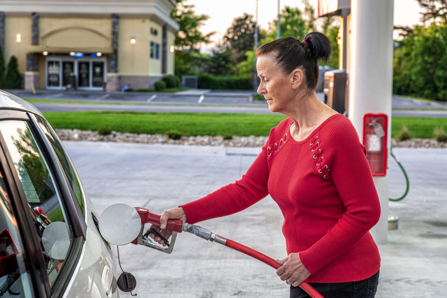 A woman pumping gas